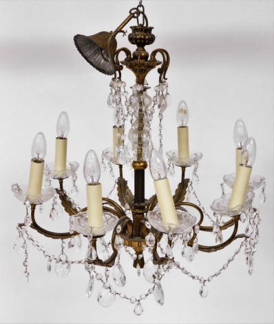 A brass framed and cut glass eight branch chandelier, with domed glass top, leaf finials droplets and eight branch arms, 62cm high and approximately 60cm wide.