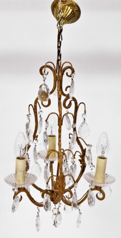 A late 20thC gilt and cut glass chandelier, with three branch arms and various droplets, 46cm high and approximately 25cm wide.