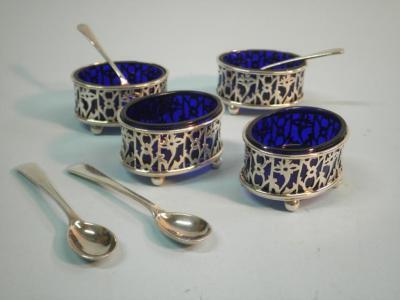 A set of four pierced oval silver salts