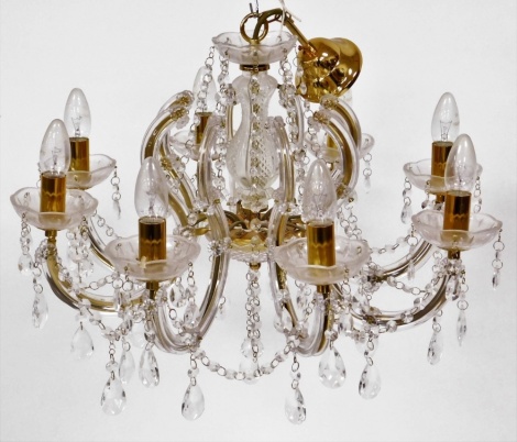 An eight branch gilt and plastic chandelier, 34cm high, 58cmn wide.