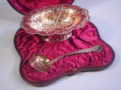 A Victorian silver gilt sugar bowl and sifter spoon each with punched and