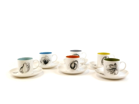 A set of Susie Cooper multicoloured coffee cans and saucers, each with designs of fruits with varying colours, the coffee cans 6cm high, the saucers 13cm diameter.