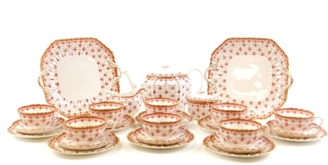 A Spode Fleur De Lys red pattern part tea service, comprising teapot, eight tea cups, milk jug, sugar bowl, eight saucers, eight side plates and two cake plates.