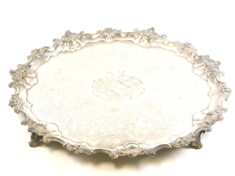 A large 19thC silver plated serving tray, the central four shield crest of the Hodges family with crescent moon and deer emblem to top and bearing the engraved wording Dant Lucem Crescentibus Orti, surrounded by various leaves and flowers with rococo scro