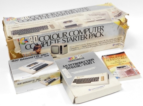 A Vic 20 colour computer starter pack introduction book, together with a 1530 Datassette unit and an Explorers Adventures of the Commodore 64 book. (4)