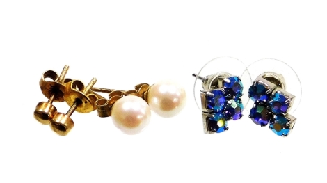 A group of various earrings, to include a pair of 9ct gold stud earrings, a pair of 9ct gold and pearl set earrings, 1.9g all in, and a pair of costume jewellery earrings. (3)