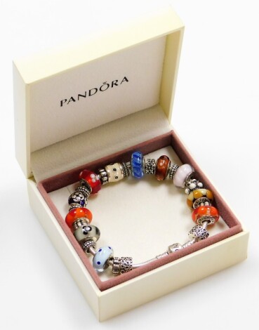 A silver Pandora bracelet and various charms, to include two weave design breakers, nine Murano bead charms, two enamelled charms and eleven further decorative breakers, the bracelet 21cm long, 75.6g all in, boxed.