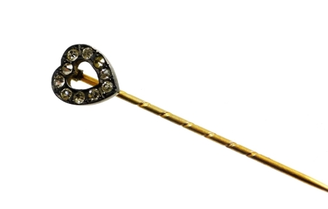 An Edwardian gilt metal stick pin, with heart shaped top set with various paste stones, 5cm high.