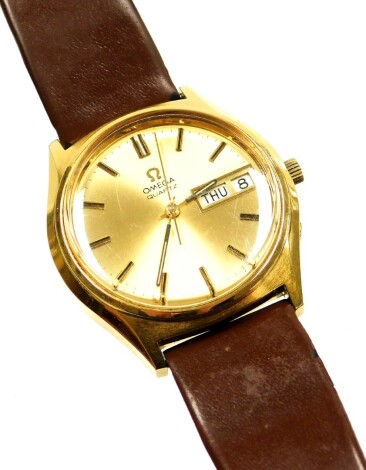 An Omega quartz gents wristwatch, in a gold plated case on a stainless steel back with a gold coloured dial and date aperture on a later brown leather strap, the dial 3.5cm wide.