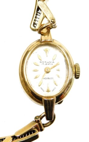 A Rodania 9ct gold ladies wristwatch, with small oval dial on expanding gold bracelet, with safety chain, the watch head 2cm high, 13.8g all in, in a Scotts of Lincoln presentation box.