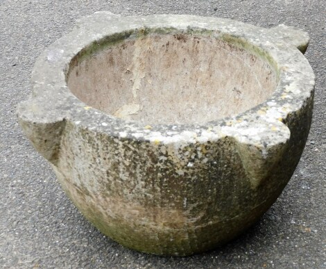 A reconstituted stone planter, of circular outline with four out strong points, 30cm high, 45cm wide.