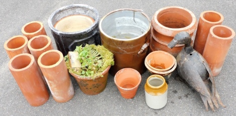 A group of garden pots and ornaments, to include terracotta turrets, a stoneware jar, various terracotta and other planters, metal duck ornament, etc. (a quantity)