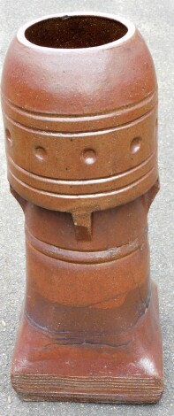 A metal and brown glazed chimney pot turret, the top with beaded design, 80cm high.