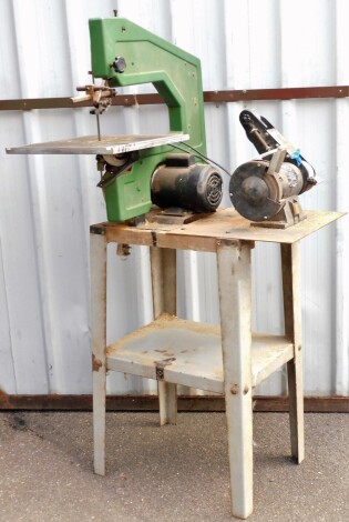 A workshop bench with various tools, to include a band saw and a bench grinder NTG6l-4.