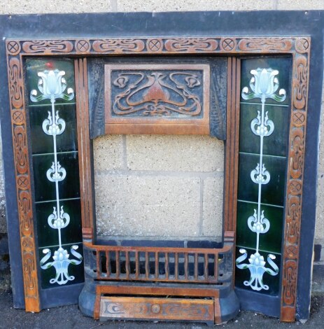 A Victorian fireplace surround, inset with five Art Nouveau type tiles to each side and with an overall Art Nouveau type decoration, 96cm high, 94cm wide, 8cm deep.