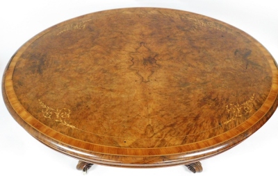 A fine Victorian burr walnut and marquetry breakfast table, with cross banded oval quarter veneered tilt top, and a jewel carved central pillar on heavy moulded cabriole legs with brass and ceramic castors, 74cm high, 146cm wide, 113cm deep. - 2