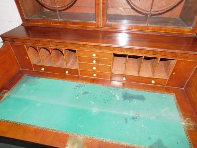 A George III mahogany secretaire bookcase, with a stepped arch pediment with satinwood stringing, flame frieze over two tall hour glass and diamond shaped astragal doors, the fall front secretaire drawer having satinwood and ebony stringing with flamed ca - 4