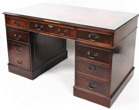 A late 20thC reproduction mahogany twin pedestal desk, with red leather gilt inset, and additional glass shelf top above one long and two short drawers, on two pedestal base, 68cm high, 137cm wide, 76cm deep. (AF)