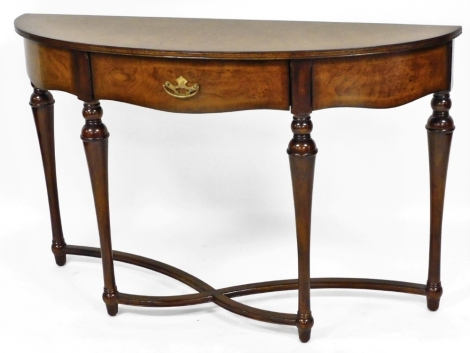 A mahogany finish console table, with curved front, on x frame curved base, 77cm high, 95cm wide, 35cm deep.