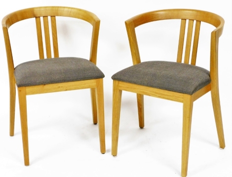 A pair of light oak Marks and Spencer dining chairs, each with curved back and three panelled back, 76cm high, 46cm wide, 42cm deep.