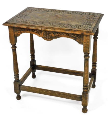 An early 20thC carved oak side table, the top with outer border of carved, on a rectangular base, 72cm high, 67cm wide, 44cm deep.