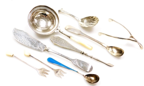 A group of various silver cutlery and trinkets, to include a silver and blue enamelled spoon, as silver and mother of pearl handled tea strainer, silver wishbone, shell spoon, pickle forks, fish knife, silver handled button hook and silver teaspoon, 4¼oz 