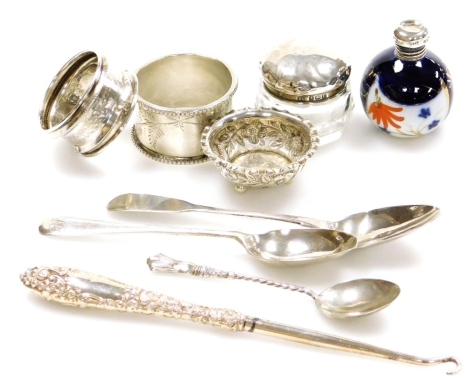 A group of small silver, to include a silver finger bowl, two silver napkin rings, two silver topped lidded jars, a white metal handled button hook stamped Sterling and three silver spoons. (9)