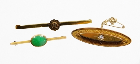 A group of bar brooches, to include a 9ct gold and jade set bar brooch, 4.5cm long, a Victorian diamond set floral bar brooch, stamped 15ct, 6cm long, and another Victorian and diamond set bar brooch, 15ct gold with safety chain, 4.5cm wide, 10.9g all in.