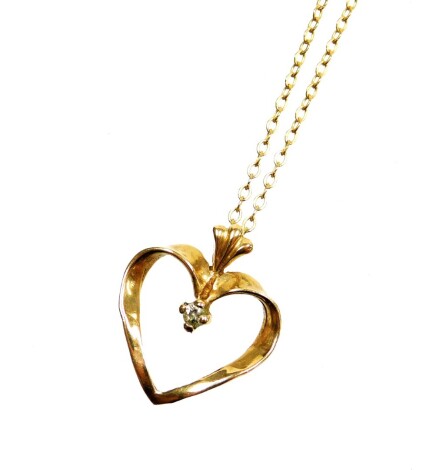 A 9ct gold heart shaped pendant and chain, the heart shaped pendant set with tiny white stone, 1.4cm high, on a fine link 9ct gold chain, 40cm long, 2g, boxed.