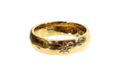 A 9ct gold thick wedding band, set with tiny round brilliant cut diamond in star setting, ring size U, 8.9g all in, boxed.