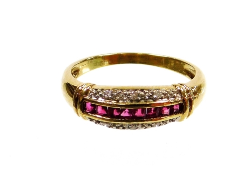 A modern dress ring, gold plated band set with imitation stones, ring size U, boxed.