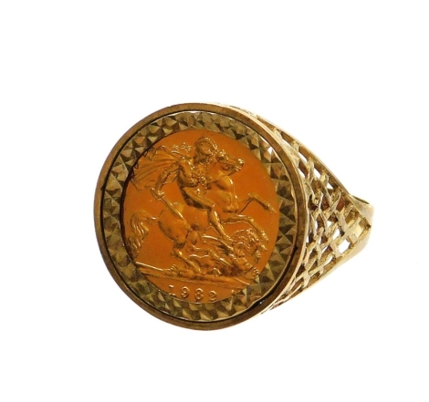 An Elizabeth II half gold sovereign ring, in 9ct gold fret work bordering, the sovereign dated 1982, ring size z, 8.4g all in, boxed.