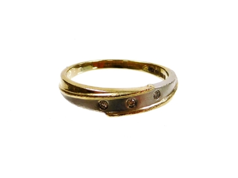 A 9ct gold dress ring, of twist design set with three tiny diamonds, ring size Q, 2.6g all in.