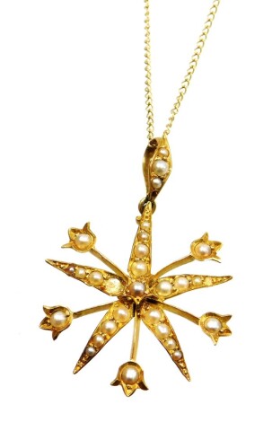 An Edwardian star pendant and chain, the star pendant set with seed pearls (some missing) on a yellow metal backing stamped 15ct, 3.5cm high, on a fine link 9ct gold chain, 44cm long, 3.5g all in, boxed.