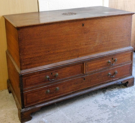 An 18thC carved oak mule chest, the top with central carved floral panel, on a stepped three drawer base, with two short and two long drawers, one handle missing, 80cm high, 120cm wide, 57cm deep.