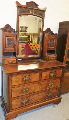 A burr walnut Edwardian dressing chest, with large central rectangular mirrored section with two cupboard stand to each side with cupboard door shelf and drawer on a two short and two long drawer base, on castors with metal handles, 192cm high, 120cm wide