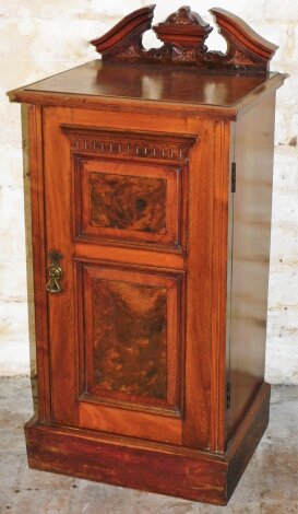 An Edwardian walnut pot cupboard, with a carved frieze above single cupboard door with two panel section, 86cm high, 39cm wide, 34cm deep.