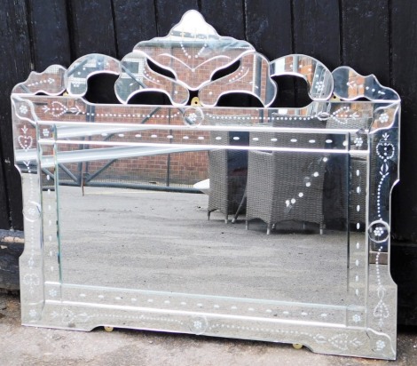 A modern rectangular mirrored glass mirror, with arched applied mirror top and pleated decoration, 81cm high, 102cm wide.