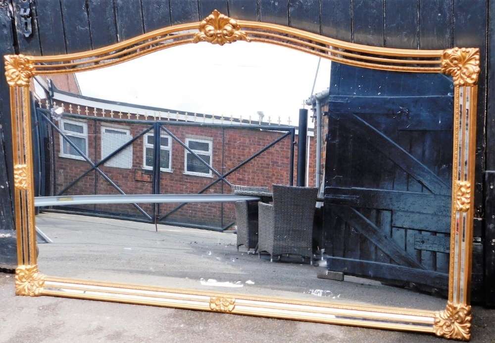 A large rectangular wall mirror, modern in design with gilt decoration