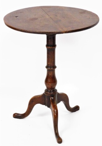 An early 19thC oak occasional table, the circular panelled top on a tripod base, 65cm high, 53cm diameter.