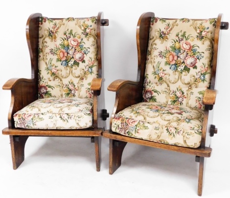 A pair of oak lounge chairs, each with a florally upholstered applied seat, 103cm high, 65cm wide, 67cm deep. (2)