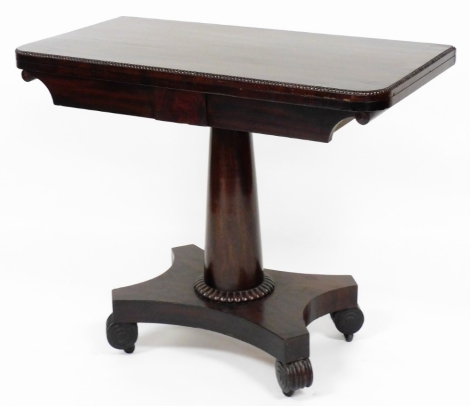 A William IV mahogany card table, with fret work border opening to reveal a green lined interior, on scroll feet with castors, 74cm high, 91cm wide, 46cm deep.