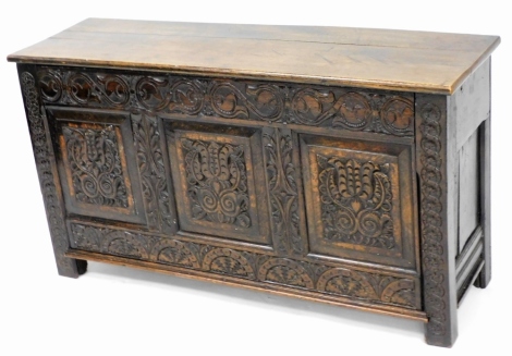 A late 19thC carved oak coffer, the two panel top above three carved panel doors, with outer moulded friezes, 65cm high, 118cm wide, 35cm deep.