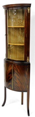 A Georgian style mahogany corner cabinet, the upper cabinet with gold floral lining, enclosed with a single glazed bowed door with gilt embellishment on double cupboard base, with splayed legs, 172cm, 52cm wide, 32cm deep.