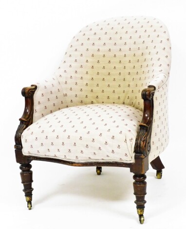 A Victorian armchair, the curved back on oak carved legs with scroll design detailing with a pale pink and red dandelion detailed material, 82cm high, 64cm wide, 70cm deep.