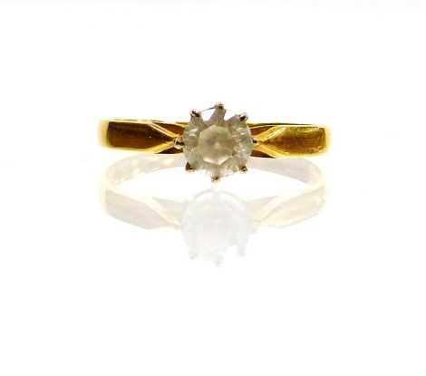 A solitaire ring, the central imitation diamond in claw setting on a yellow metal band stamped 750, ring size I½, 1.7g all in.