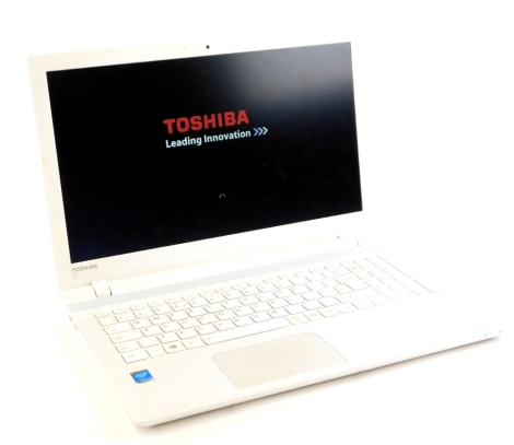 A Toshiba Satellite laptop, in white with intelcore i5 processor, serial number 9F193775C, with charger cable.