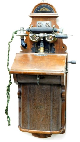 A British LM Ericsson vintage wall hanging telephone, in shaped case with domed top, chrome plated metal bells and shaped receiver attached by a green cord, 68cm high.