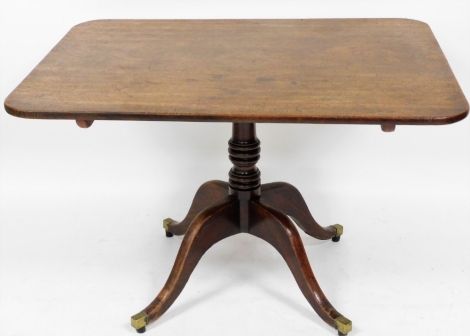 A George III mahogany breakfast table, the rectangular top with canted rounded corners on a four sabre leg base with brass castors, 72cm high, 102cm wide, 85cm deep.