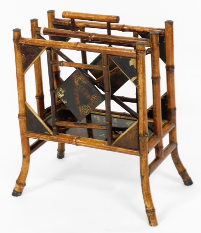 A Japanese lacquered bamboo magazine rack, with two slots and detailing of birds and flowers with metal cap ends, 51cm high, 40cm wide, 22cm deep.